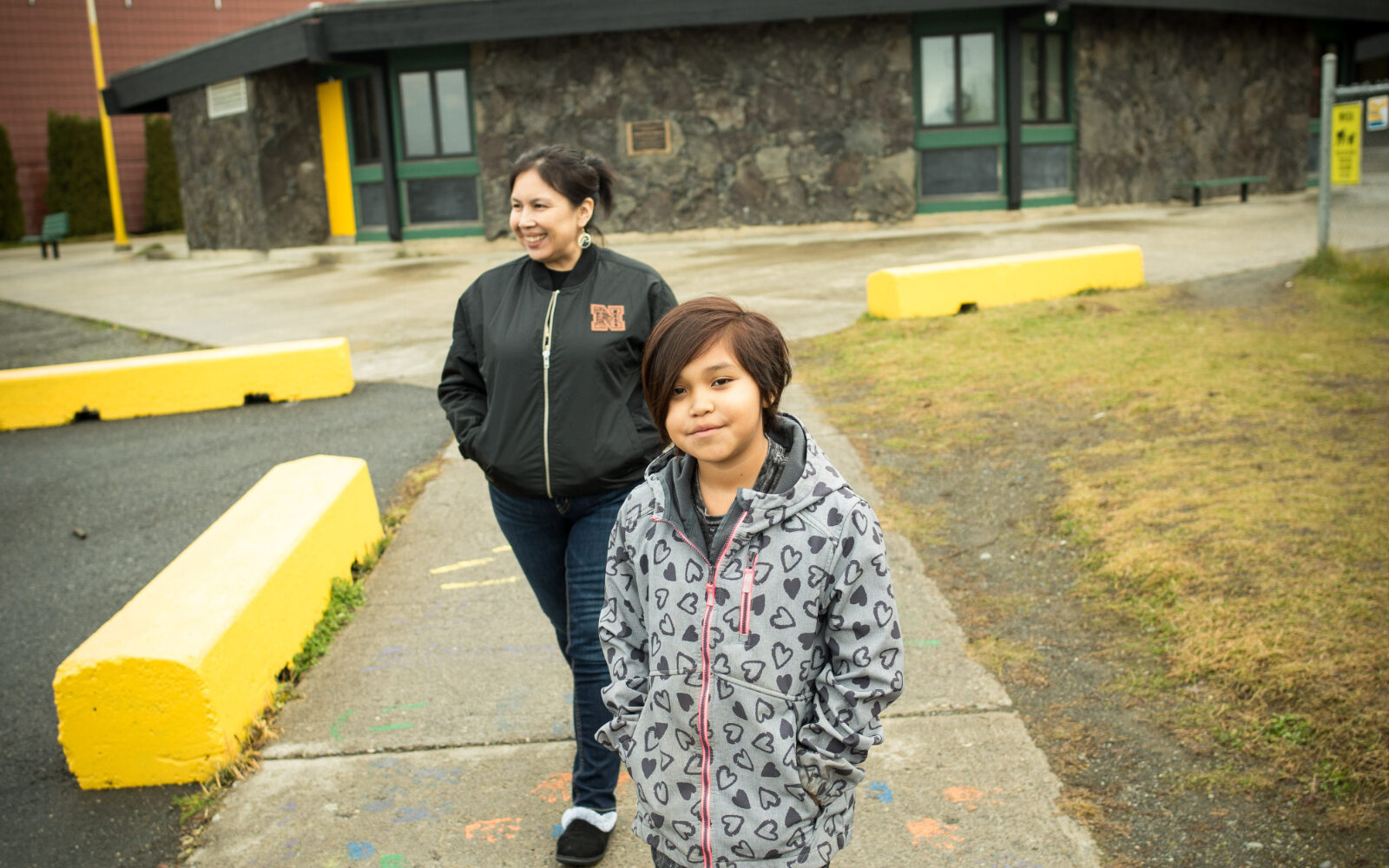 Nisga'a School District 92 teacher and parent standing in front of the school